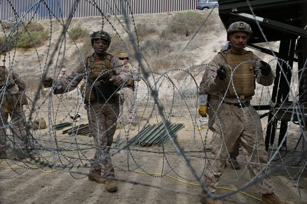 February 6, 2025, Tijuana, Baja California, Mexico: Members of the US Marine Corps install concertina wire along the US-Mexico border wall in San Diego, California, seen from Tijuana, Mexico in between the San Diego-Tijuana border fences of Colonia Libertad on Thursday, February 06, 2025. The Defense Department deployed 1,600 active-duty troops to the border during US President Donald Trumpâ€⠢s first week in office. Tijuana Mexico - ZUMAm180 20250206_zip_m180_013 Copyright: xCarlosxA.xMorenox