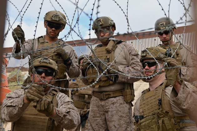 February 6, 2025, Tijuana, Baja California, Mexico: Members of the US Marine Corps install concertina wire along the US-Mexico border wall in San Diego, California, seen from Tijuana, Mexico in between the San Diego-Tijuana border fences of Colonia Libertad on Thursday. The Defense Department deployed 1,600 active-duty troops to the border during US President Trump s first week in office. Tijuana Mexico - ZUMAm180 20250206_zip_m180_008 Copyright: xCarlosxA.xMorenox