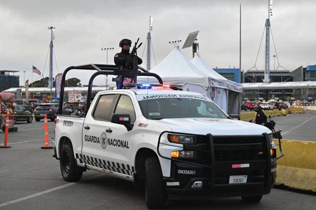 February 6, 2025, Tijuana, Baja California, Mexico: A Mexican National Guard officer on a pickup truck stands guard during a check on vehicles heading to the United States into San Diego, California at the San Ysidro Port of Entry crossing in Tijuana, Baja California, Mexico, on Thursday, February 6, 2025. At the southern border between the US and Mexico a planned distribution of 10,000 Mexican National Guard troops on the US border, under an agreement with US President Donald Trump to stop the flow of migration and drugs like fentanyl. Tijuana Mexico - ZUMAm180 20250206_zip_m180_027 Copyright: xCarlosxA.xMorenox