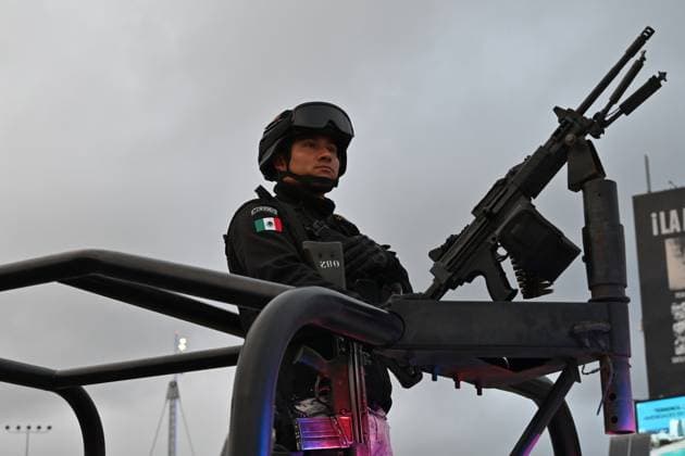 February 6, 2025, Tijuana, Baja California, Mexico: A Mexican National Guard officer on a pickup truck stands guard during a check on vehicles heading to the United States into San Diego, California at the San Ysidro Port of Entry crossing in Tijuana, Baja California, Mexico, on Thursday, February 6, 2025. At the southern border between the US and Mexico a planned distribution of 10,000 Mexican National Guard troops on the US border, under an agreement with US President Donald Trump to stop the flow of migration and drugs like fentanyl. Tijuana Mexico - ZUMAm180 20250206_zip_m180_032 Copyright: xCarlosxA.xMorenox