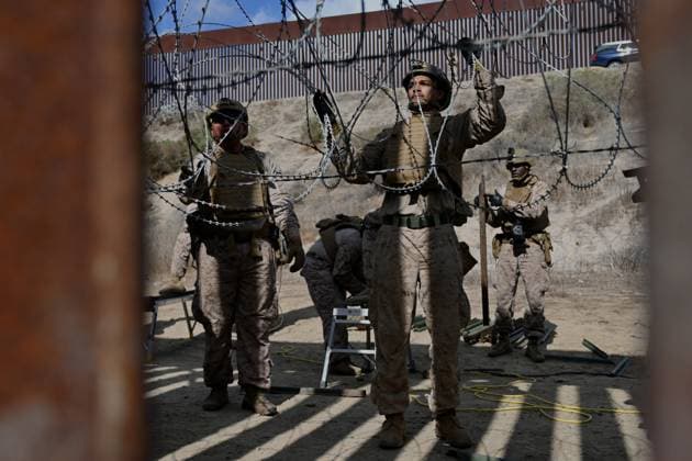 February 6, 2025, Tijuana, Baja California, Mexico: Members of the US Marine Corps install concertina wire along the US-Mexico border wall in San Diego, California, seen from Tijuana, Mexico in between the San Diego-Tijuana border fences of Colonia Libertad on Thursday, February 06, 2025. The Defense Department deployed 1,600 active-duty troops to the border during US President Donald Trump s first week in office. Tijuana Mexico - ZUMAm180 20250206_zip_m180_003 Copyright: xCarlosxA.xMorenox