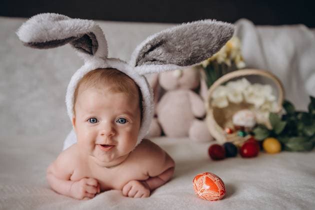 Cute little baby wearing bunny ears for Easter. Near Easter eggs. looks into the camera and smiles. High quality photo, model released, , 50649614.jpg, child, holiday, kid, spring, easter, tradition, cute, egg, happy, home, celebrate, happiness, little, family, bunny, rabbit, beautiful, celebration, girl, play, basket, childhood, colorful, fun, funny, young, decoration, event, hand, traditional, bunny ears, festive, hunt, smile, paint, preparation, children, background, color, costume, season, symbol, togetherness, caucasian, ears, christian, coloring, craft, joy, enjoy RECORD DATE NOT STATED