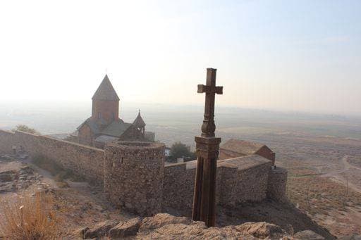 Historic Khor Virap Monastery in Armenia with a cross in the foreground, set against a hazy landscape. 28881385 RECORD DATE NOT STATED