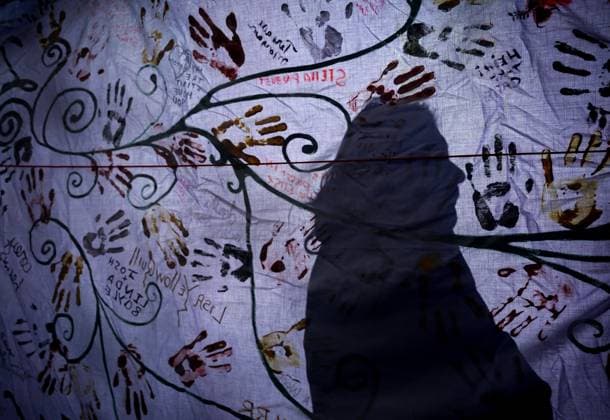 February 14, 2025, Vancouver, Bc, CANADA: A person casts their shadow on a banner with handprints and names before the annual Women s Memorial March, in Vancouver, on Friday, February 14, 2025. The march is held to honour missing and murdered Indigenous women and girls from the community with stops along the way to commemorate where women were last seen or found. Vancouver CANADA  - ZUMAc35_ 20250214_zaf_c35_123 Copyright: xDarrylxDyckx