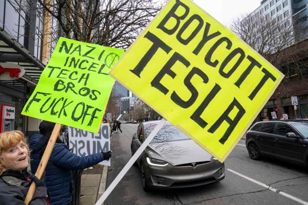 February 15, 2025, Seattle, Washington, USA: People protest against Elon Musk outside a Tesla car dealership in the South Lake Union area of Seattle, Washington, USA, on Sat., Feb. 15, 2025. In recent weeks, Elon Musk has spearheaded an initiative in the Trump administration called the Department of Government Efficience (DOGE), which has implemented or attempted to implement, widespread budget and personnel cuts across the Executive Branch of the US federal government. The protest sign here says Boycott Tesla. Seattle USA - ZUMAb344 20250215_znp_b344_013 Copyright: xScottxBrauerx