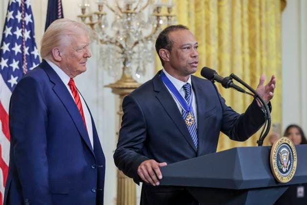 Golfer Tiger Woods speaks as US President Donald J. Trump watches during a reception honoring Black History Month in the East Room of the White House in Washington, DC, on February 20, 2025.  WAX20250220807 SHAWNxTHEW
