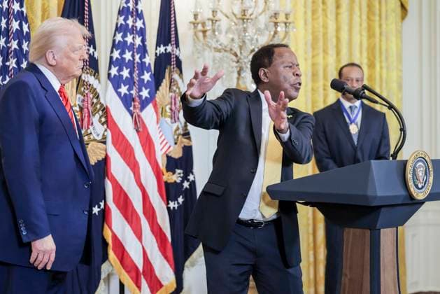 Attorney Leo James Terrell (C) speaks while standing with US President Donald J. Trump (L) and golfer Tiger Woods (R) during a reception honoring Black History Month in the East Room of the White House in Washington, DC, on February 20, 2025.  WAX20250220866 SHAWNxTHEW