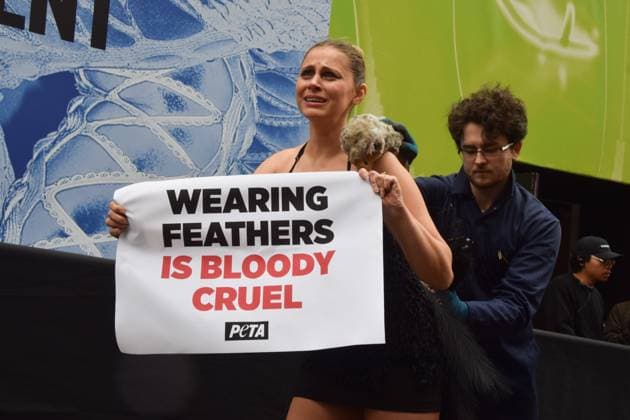 February 21, 2025, London, England, UK: A PETA activist dressed as an ostrich has her feathers violently plucked outside the London Fashion Week NEWGEN show space on The Strand. The action is part of the ongoing PETA campaign against the use of feathers in fashion. London UK - ZUMAv130 20250221_zip_v130_018 Copyright: xVukxValcicx
