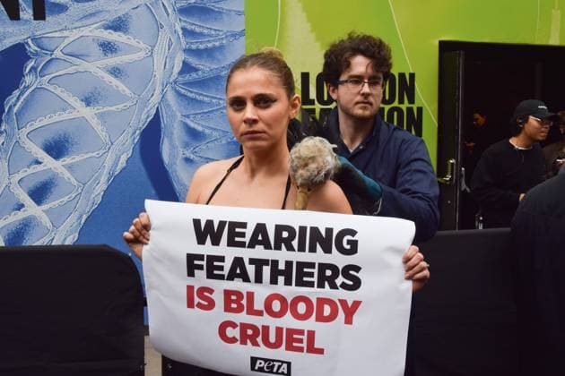February 21, 2025, London, England, UK: A PETA activist dressed as an ostrich has her feathers violently plucked outside the London Fashion Week NEWGEN show space on The Strand. The action is part of the ongoing PETA campaign against the use of feathers in fashion. London UK - ZUMAv130 20250221_zip_v130_021 Copyright: xVukxValcicx