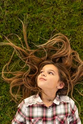 Creative Highlights Symbolfotos Smiling girl with long hair lying on a meadow model released, Symbolfoto, ERRF00690