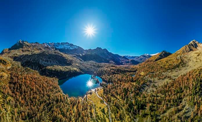 Drone view of Lago di Val Viola lake amidst Livigno Alps under blue sky at sunny day, ANSF01339