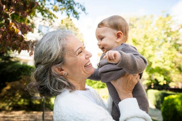 Creative Highlights Symbolfotos Happy gray haired mature woman picking up grandson model released, Symbolfoto, AAZF02167