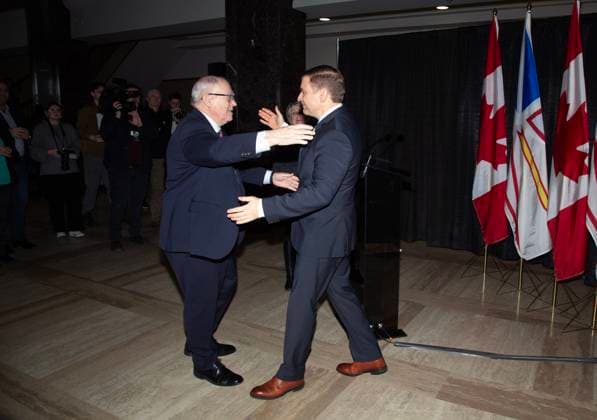 February 25, 2025, St. John s, Nl, CANADA: Newfoundland and Labrador Premier Andrew Furey prepares to embrace his father, George, a longtime member and former speaker of the Senate in St.John s on Tuesday, Feb. 25, 2025. The premier held an unanticipated news conference where he announced his resignation as premier. St. John s CANADA  - ZUMAc35_ 20250225_zaf_c35_034 Copyright: xPaulxDalyx