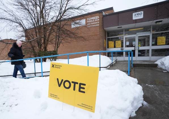 February 27, 2025, Mississauga, On, CANADA: A person walks in to vote in the Ontario provincial election at a school in Mississauga, Ont., on Thursday, Feb. 27, 2025. Mississauga CANADA  - ZUMAc35_ 20250227_zaf_c35_003 Copyright: xNathanxDenettex