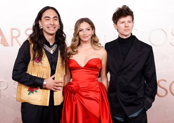 (L-R) Julian Brave NoiseCat, Emily Kassie and Kellen Quinn arrive on the red carpet for the 97th Academy Awards in the Hollywood section of Los Angeles on Sunday, March 2, 2025.  LAP20250302723 JOHNxANGELILLO
