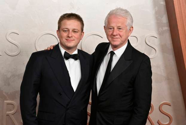 Richard Curtis (on the right) arrives on the red carpet for the 97th Academy Awards in the Hollywood section of Los Angeles on Sunday, March 2, 2025.  LAP20250302479 JIMxRUYMEN