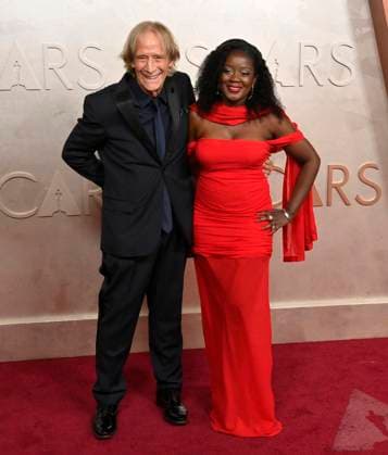 (L-R) John Bloom and Tonye arrive on the red carpet for the 97th Academy Awards in the Hollywood section of Los Angeles on Sunday, March 2, 2025.  LAP20250302486 JIMxRUYMEN