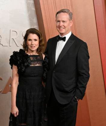 Mike Cavanagh (on the right) arrives on the red carpet for the 97th Academy Awards in the Hollywood section of Los Angeles on Sunday, March 2, 2025.  LAP20250302488 JIMxRUYMEN