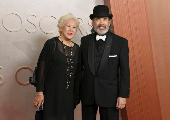 Chris Tashima (on the right) arrives on the red carpet for the 97th Academy Awards in the Hollywood section of Los Angeles on Sunday, March 2, 2025.  LAP20250302497 JIMxRUYMEN