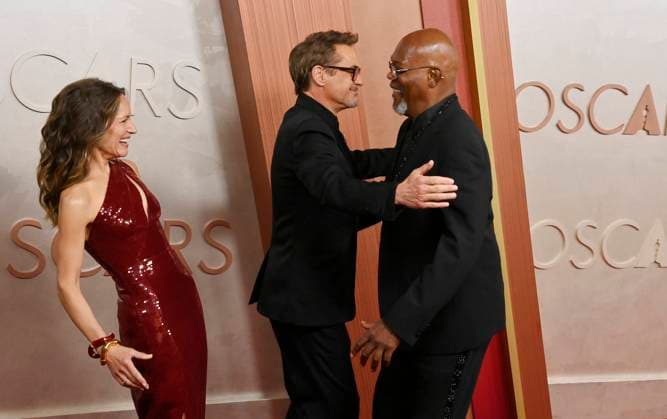 Samuel L. Jackson (R) surprises Robert Downey Jr. (C) and his wife Susan Downey on the red carpet during the 97th Academy Awards at the Dolby Theatre in the Hollywood section of Los Angeles on Sunday, March 2, 2025.  LAP20250302513 JIMxRUYMEN