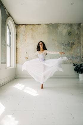 Creative Highlights Symbolfotos Ballerina in a flowing white dress spins gracefully in soft light Newburyport, Massachusetts, United States CR_FKNH250302-1660640-01 ,model released, Symbolfoto