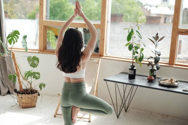 Woman Practicing Yoga in Bright Room with Plants Lviv, Lviv Oblast, Ukraine CR_JUCE250228A-1670949-01 ,model released, Symbolfoto