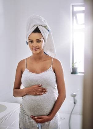 Creative Highlights Symbolfotos Happy woman, portrait and towel with pregnant stomach in bathroom for hygiene or expecting mother at home. Female person, pregnancy or holding with belly for health, care or maternity at house. model released property released Copyright: xwww.peopleimages.comx