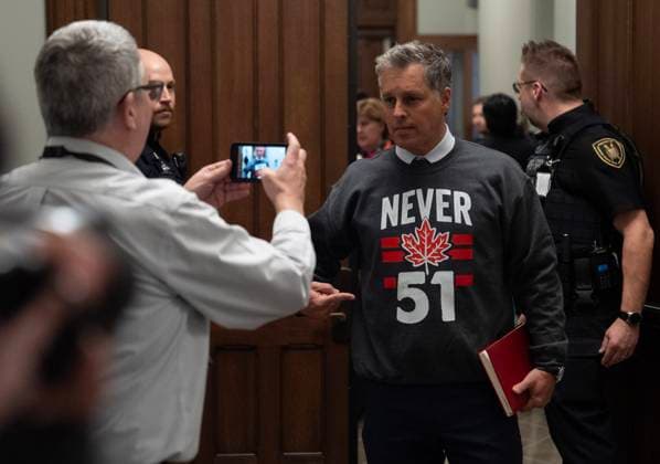 March 10, 2025, Ottawa, On, Canada: A reporter videos Liberal MP for Vaudreuil-Soulanges Peter Schiefke as he heads to a caucus meeting wearing a Never 51 sweater, Monday, March 10, 2025 in Ottawa. Ottawa Canada  - ZUMAc35_ 20250310_zaf_c35_039 Copyright: xAdrianxWyldx