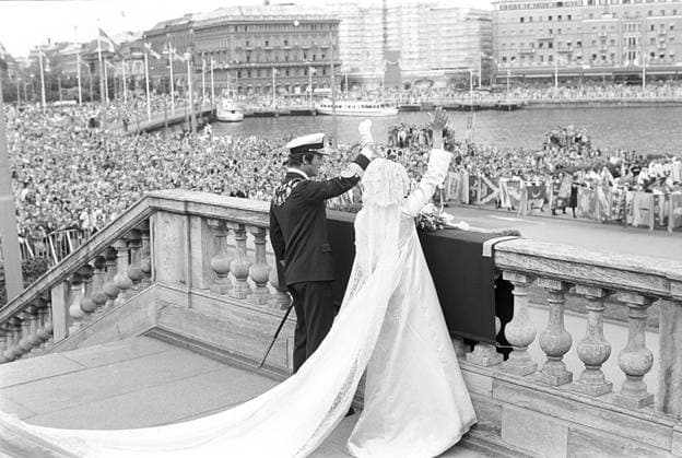 Hochzeit von Carl XVI. Gustaf und Silvia Sommerlath. Carl XVI. Gustaf, König von Schweden. Geboren am 30. April 1946. Die Hochzeit am 19. Juni 1976 in Stockholm. Königin Silvia in ihrem Hochzeitskleid mit König Carl XVI. Gustaf auf der Treppe des königlichen Schlosses in Stockholm mit einer jubelnden Menschenmenge im Hintergrund Wedding of Carl XVI Gustaf and Silvia Sommerlath. Carl XVI Gustaf, King of Sweden. Born 30 april 1946. The wedding 19 june 1976 in Stockholm. Queen Silvia in her wedding dress with king Carl XVI Gustaf on the stairway to the royal castle in Stockholm with crowds of people in the background cheering Copyright: imageBROKER Sjoberg ibljsj12891620.jpg