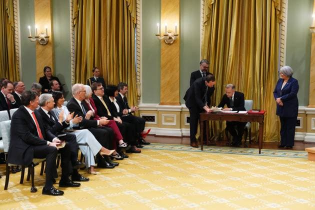 March 14, 2025, Ottawa, On, Canada: Prime Minister Mark Carney signs after being sworn in during a ceremony at Rideau Hall in Ottawa on Friday, March 14, 2025. Ottawa Canada  - ZUMAc35_ 20250314_zaf_c35_183 Copyright: xSeanxKilpatrickx