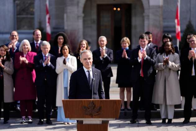March 14, 2025, Ottawa, On, Canada: Prime Minister Mark Carney makes his way to hold a press conference as members of his cabinet look on following a swearing in ceremony at Rideau Hall in Ottawa on Friday, March 14, 2025. Ottawa Canada  - ZUMAc35_ 20250314_zaf_c35_197 Copyright: xJustinxTangx