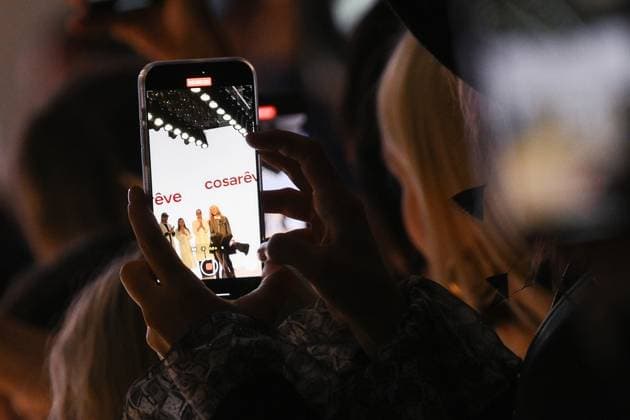 Russia Moscow Fashion Week 8880375 16.03.2025 A visitor films the presentation of creations by the brand COSAREVE during the 4th Moscow Fashion Week at the Manege Central Exhibition Hall in Moscow, Russia. Grigory Sysoev Sputnik Moscow Russia  Copyright: xGrigoryxSysoevx