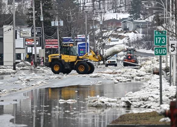 March 17, 2025, Beauceville, Pq, Canada: A payload carries a block of ice left on the highway 183 in Beauceville, Que., Monday, March 17, 2025. The Chaudiere river flooded the city after an ice blockage overnight. Beauceville Canada  - ZUMAc35_ 20250317_zaf_c35_085 Copyright: xJacquesxBoissinotx