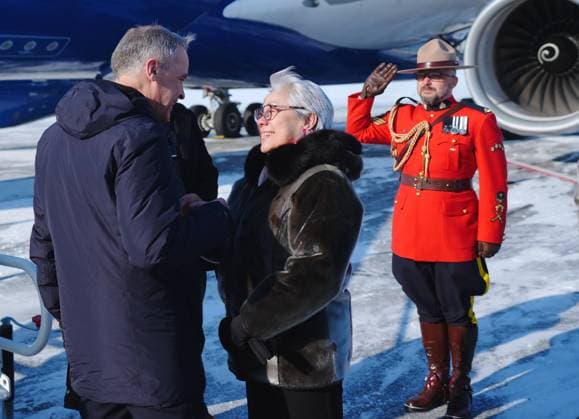 March 18, 2025, Iqaluit, Nunavut, Canada: Prime Minister Mark Carney, left, is greeted by Commissioner of Nunavut Eva Aariak as he arrives in Iqaluit, Nunavut, on Tuesday, March 18, 2025. Iqaluit Canada - ZUMAc35_ 20250318_zaf_c35_018 Copyright: xSeanxKilpatrickx
