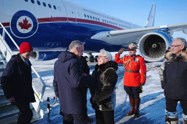 March 18, 2025, Iqaluit, Nunavut, Canada: Prime Minister Mark Carney, centre, is greeted by Commissioner of Nunavut Eva Aariak, right, as he and his wife Diana Fox Carney arrive in Iqaluit, Nunavut, on Tuesday, March 18, 2025. Iqaluit Canada - ZUMAc35_ 20250318_zaf_c35_019 Copyright: xSeanxKilpatrickx