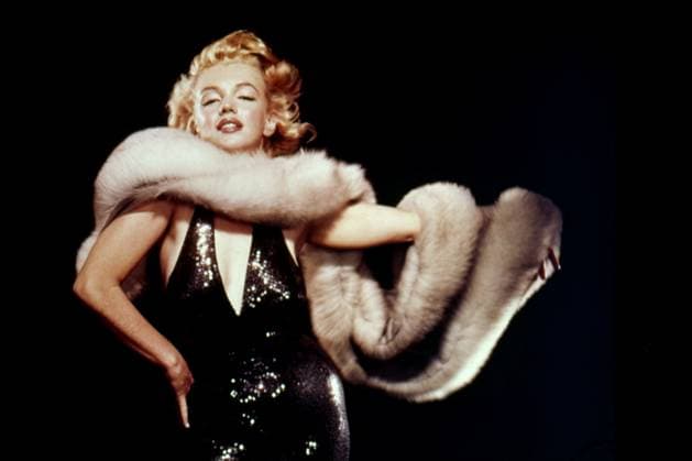 RECORD DATE NOT STATED Marilyn Monroe Circa 1956 in Los Angeles, California: American actress and Hollywood icon MARILYN MONROE poses in a low cut black sequin dress and long fur stole in this classic portrait. Copyright: x1956,entertainment,color,film,Hollywood,MarilynxMonroe,movies,vintage,classic,classicxHollywood,1950 s,vintagexHollywood,GoldenxAgexofxHollywood,x