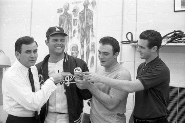 RECORD DATE NOT STATED Don Drysdale Circa 1968 in Los Angeles, California: LA Dodgers MLB baseball player DON DRYSDALE with three friends holds a LA Dodgers baseball signed with 190 at an event in 1960 s Hollywood. Copyright: x1968,entertainment,DonxDrysdale,film,Hollywood,movies,vintage,classic,1960 S,classicxHollywood,vintagexHollywood,GoldenxAgexofxHollywood,x