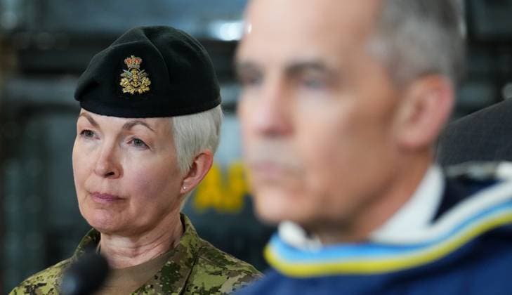 March 18, 2025, Iqaluit, Nunavut, Canada: Chief of Defence Staff Gen. Jennie Carignan, left, looks on as Prime Minister Mark Carney makes an announcement at a Canadian Armed Forces forward-operating location in Iqaluit, Nunavut, on Tuesday, March 18, 2025. Iqaluit Canada - ZUMAc35_ 20250318_zaf_c35_047 Copyright: xSeanxKilpatrickx
