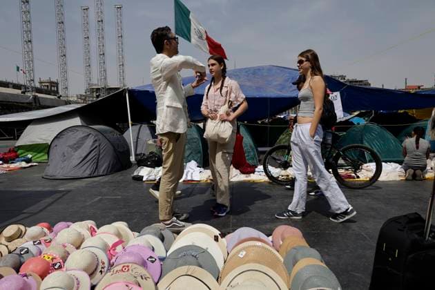 Members Of The National Coordinator Of Education Workers Set Up A Sit-in In Mexico City s Zocalo Tourists approach members of the National Coordinator of Education Workers who set up a protest in Mexico City, Mexico, on March 20, 2025. They demand that the Mexican government provide evidence that it has eliminated its initiative to reform the ISSSTE Law, which seeks to change the calculation of the fees that government workers must pay to the institution when their income exceeds 10 Units of Measurement and Update (UMA) per month, or more than 30,000 Mexican pesos per month. Mexico City Mexico City Mexico  Copyright: xGerardoxVieyrax originalFilename: vieyra-notitle250320_npoUU.jpg