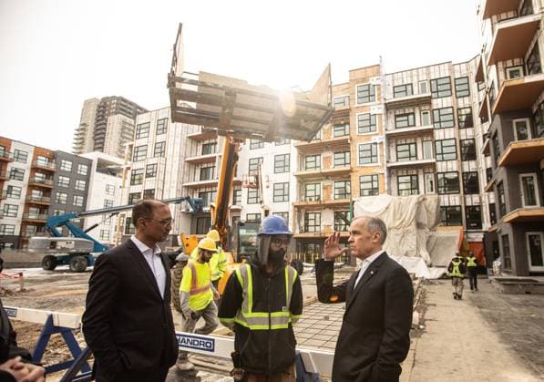 March 20, 2025, Edmonton, Ab, CANADA: Prime Minister Mark Carney, right and Edmonton Mayor Amarjeet Sohi meet with workers after announcing funding for houses during a visit to Edmonton, Thursday, March 20, 2025. Edmonton CANADA  - ZUMAc35_ 20250320_zaf_c35_117 Copyright: xJasonxFransonx