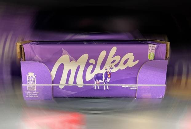 ATTENTION IMAGE EDITED Here is the view in the supermarket, discounter on Milka chocolate 100 Alpine milk from Mondelez, candy, bar, the background was dynamically blurred
