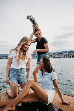 Happy female friends having fun on a boat trip on a lake model released, Symbolfoto property released, LHPF00946