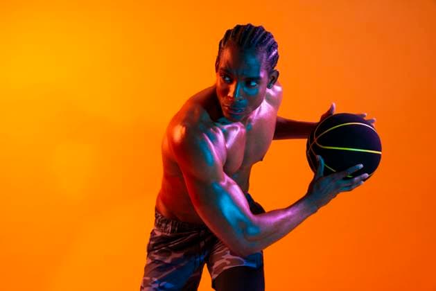 Creative Highlights Symbolfotos Athlete holding a basketball in a studio with colorful lighting model released, Symbolfoto, OIPF04616