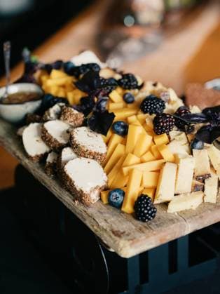 Rustic cheese board with aged cheeses, berries, and nuts on a wo United States, Colorado, Denver R_FBJQ250320B-1682907-01