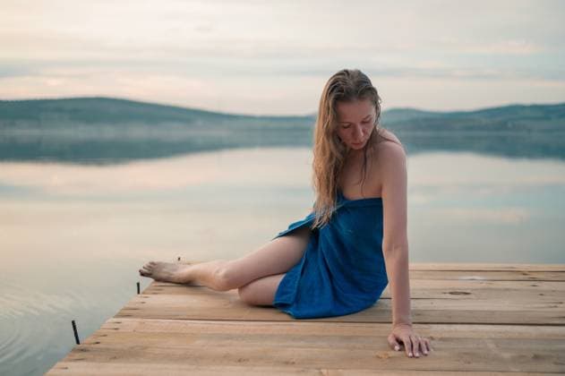 Creative Highlights Symbolfotos Woman in Blue Towel Sitting on Dock Woman in Blue Towel Sitting on Dock ,model released, Symbolfoto Copyright: xZoonar.com RuslanxOlinchukx 23037119 ,model released, Symbolfoto ,property released