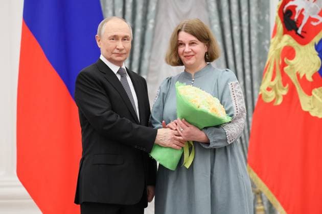 RUSSIA, MOSCOW - MARCH 25, 2025: Russia s President Vladimir Putin (L) and Russian Presidential Prize winner, illustrator Olga Ionaitis are seen during a ceremony in the Kremlin to present Russian Presidential Prizes in Culture, Literature and Art for Year 2024 to young professionals for their works aimed at children and youth. Sergei Savostyanov TASS  79356500