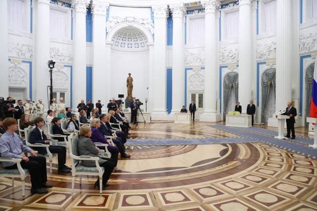 RUSSIA, MOSCOW - MARCH 25, 2025: Russia s President Vladimir Putin (R) speaks during a ceremony in the Kremlin to present Russian Presidential Prizes in Culture, Literature and Art for Year 2024 to young professionals for their works aimed at children and youth. Vyacheslav Prokofyev Russian Presidential Press and Information Office TASS  79356974
