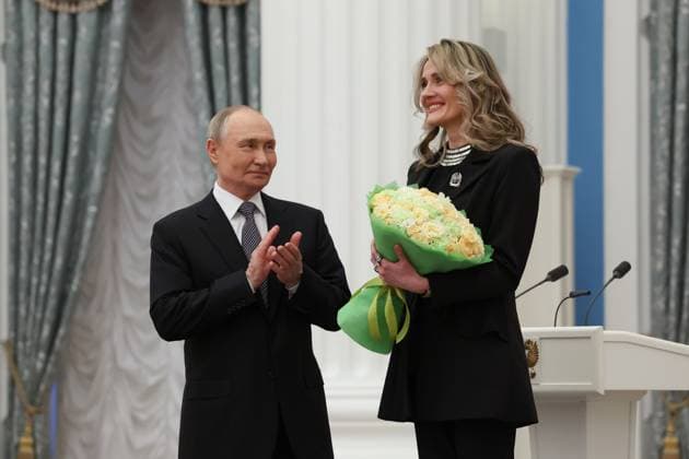 RUSSIA, MOSCOW - MARCH 25, 2025: Russia s President Vladimir Putin (L) and Loktev Song and Dance Ensemble head choir master Anna Averyanenko are seen during a ceremony in the Kremlin to present Russian Presidential Prizes in Culture, Literature and Art for Year 2024 to young professionals for their works aimed at children and youth. Vyacheslav Prokofyev Russian Presidential Press and Information Office TASS  79357367