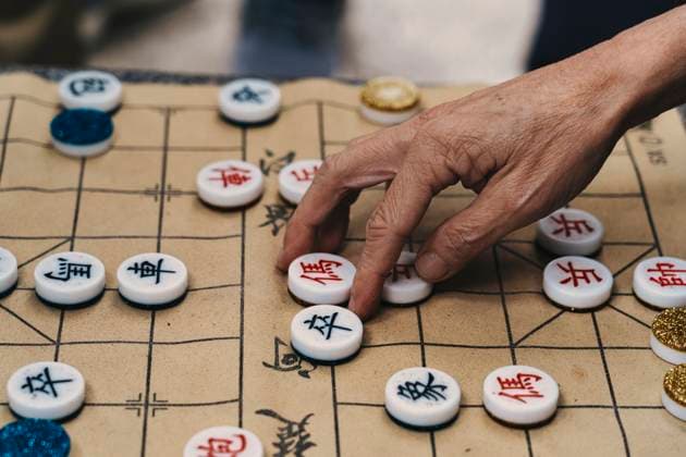 Creative Highlights Symbolfotos MR_ID27387_20196_JoseJavierBallester.jpg Cropped close-up of an unrecognizable elderly person s hand selectively placing tiles on the Chinese board game Xiangqi in Hong Kong Model Released JavierBallester_ID27387_785673_013 Copyright: xJavierxBallesterx