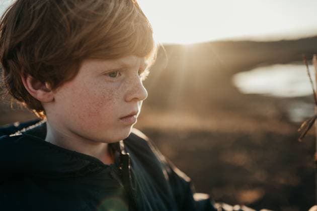 Creative Highlights Symbolfotos Young boy with serious expression outdoors in sunlight Granger, Iowa, United States CR_LIPF250404A-1694448-01 ,model released, Symbolfoto